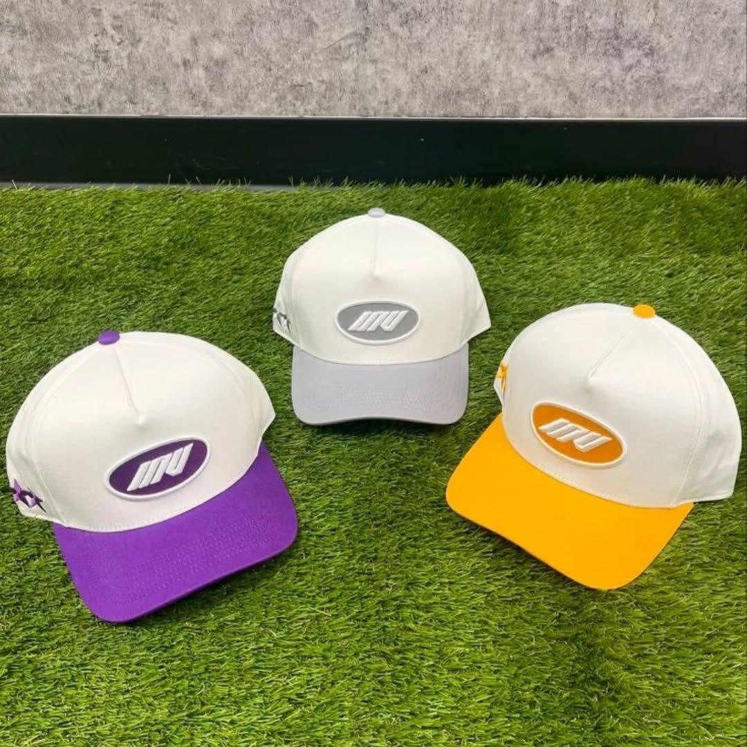 Three custom white trucker caps with purple grey and orange brims
