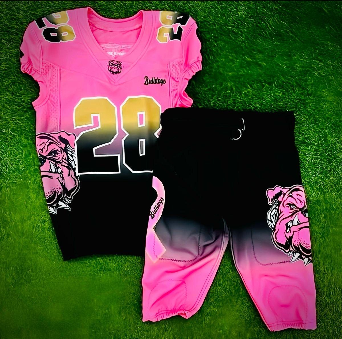Pink and black sublimated football jersey and pants with team number