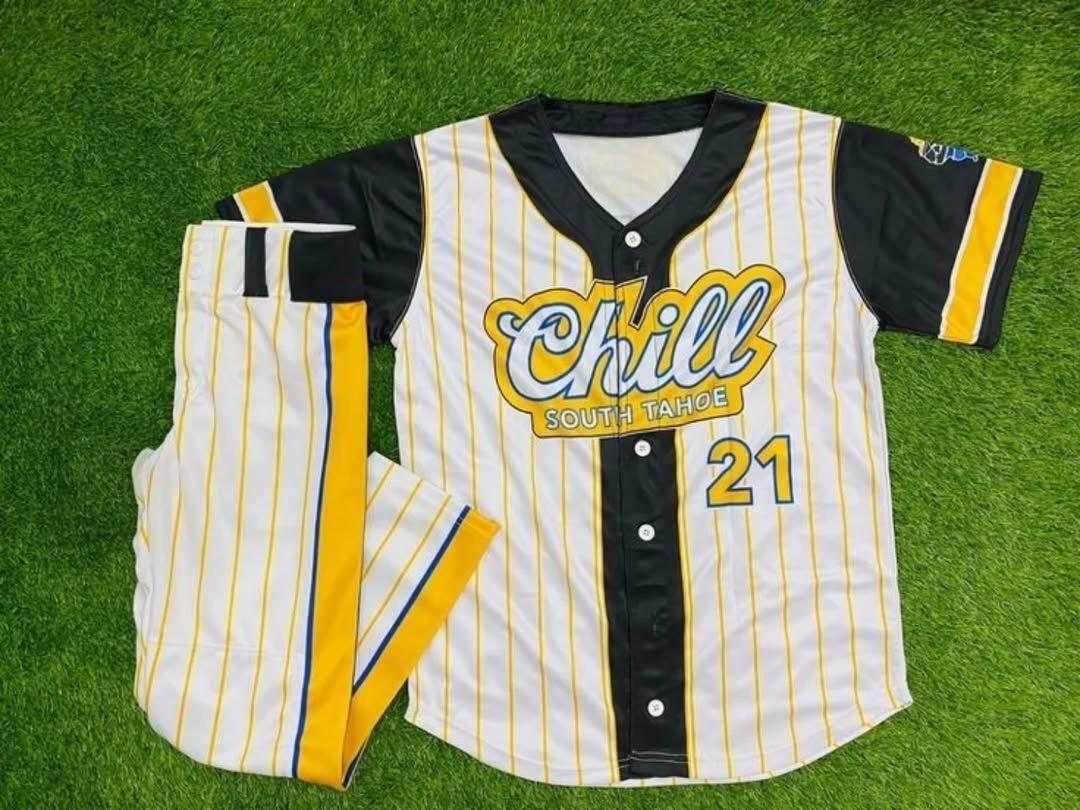 Custom white yellow pinstripe baseball jersey and pants uniform set on turf